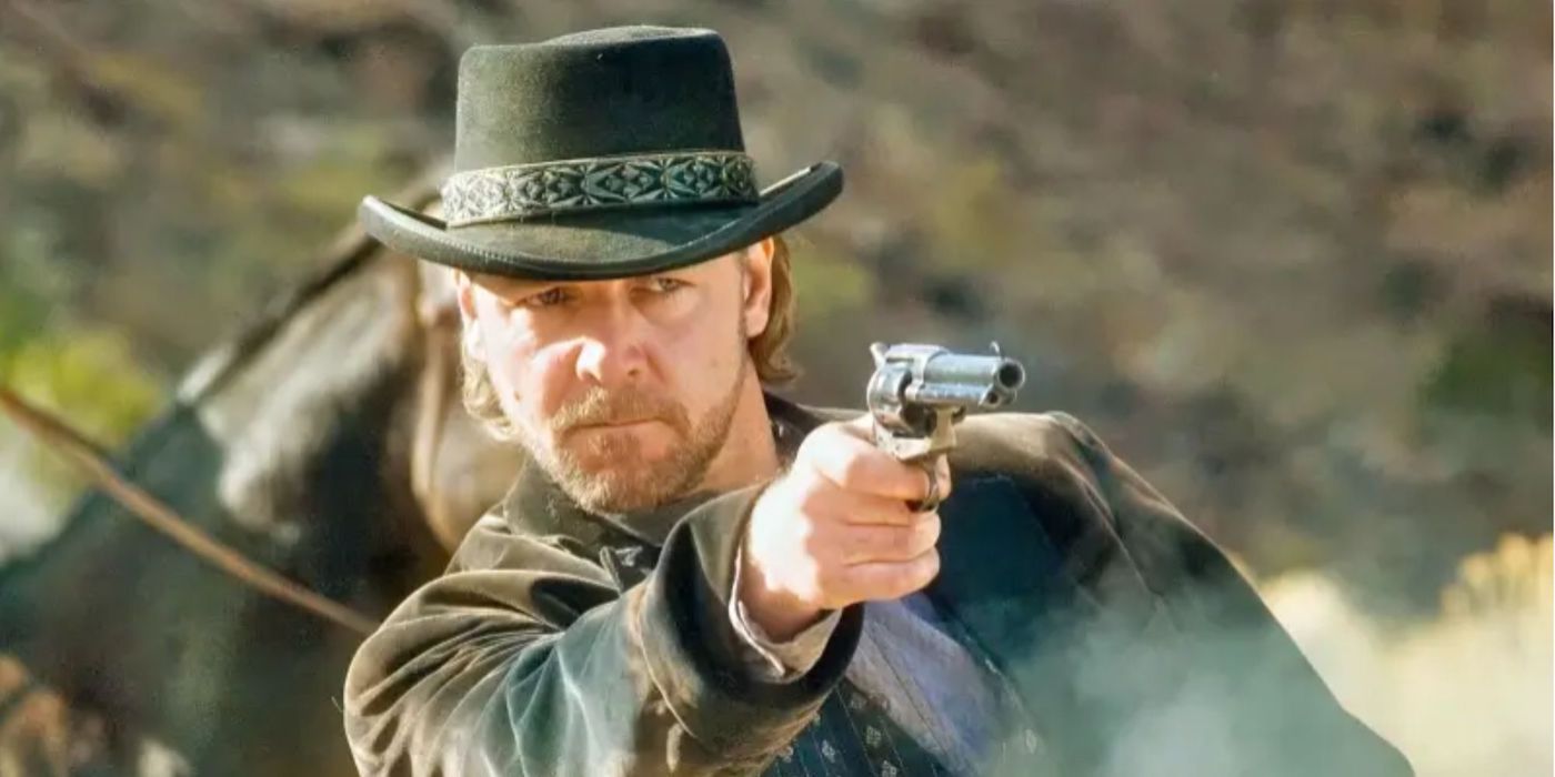 Outlaw gunslinger Ben Wade (Russell Crowe) aims his revolver in a field.