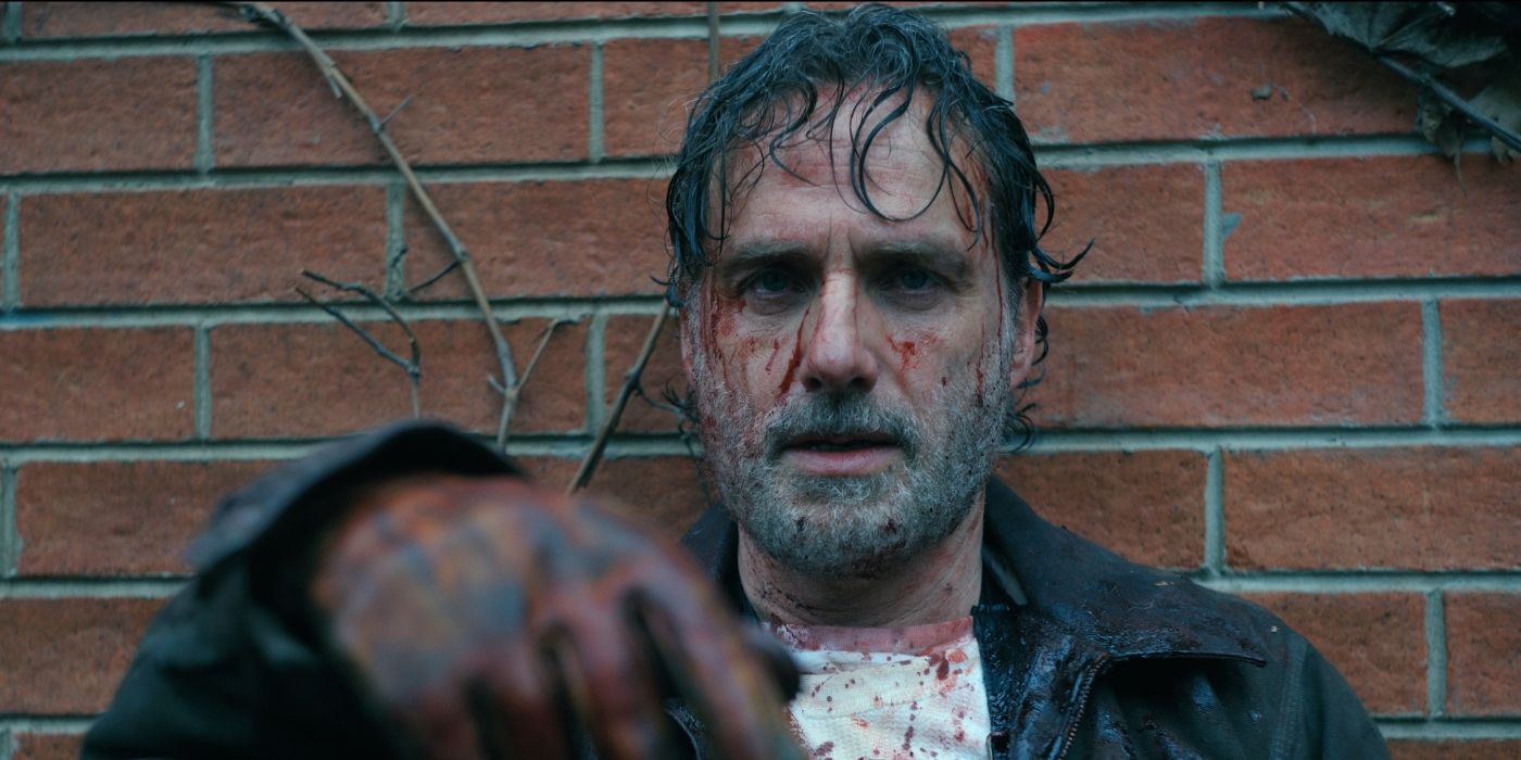 Andrew Lincoln as Rick Grimes bloodied and exhausted against a wall in The Walking Dead: The Ones Who Live