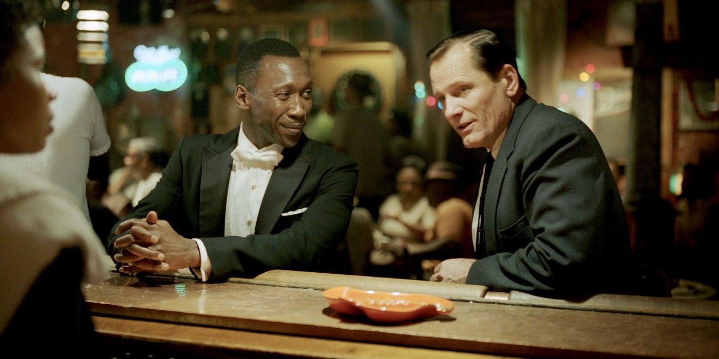 Don Shirley and Tony Lip at a bar, talking to bartender in Green Book
