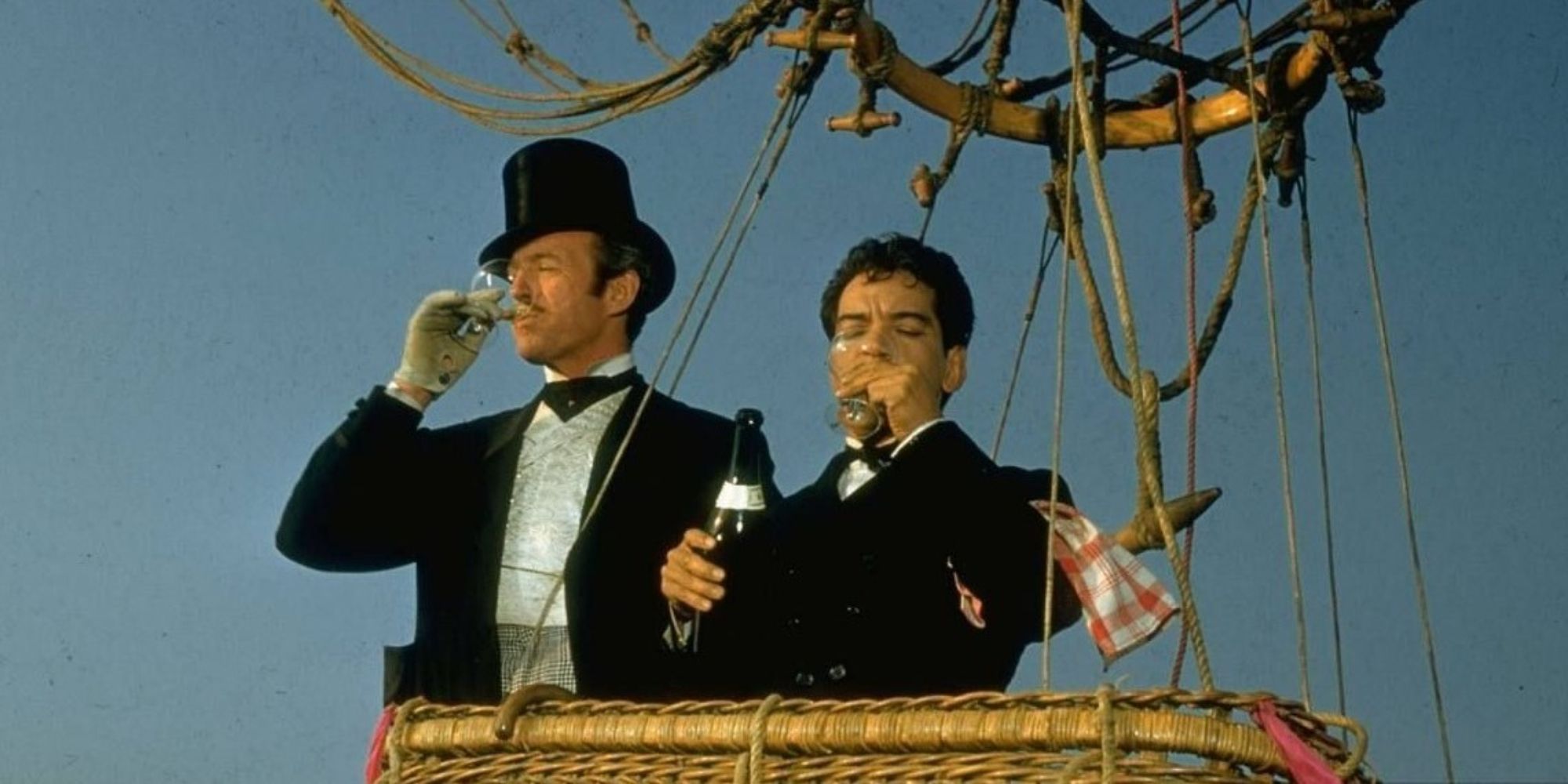 Phileas Fogg and Passepartout standing in a hot air balloon and drinking champagne in Around the World in Eighty Days