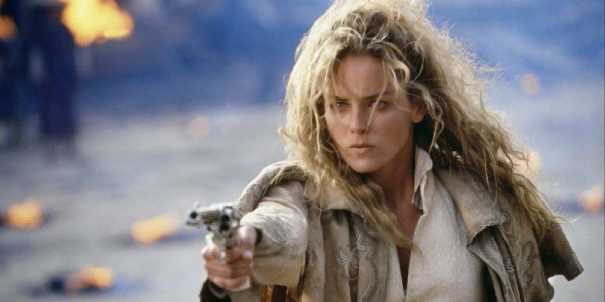 Sharon Stone as Ellen aiming a gun at someone off-camera in The Quick and the Dead