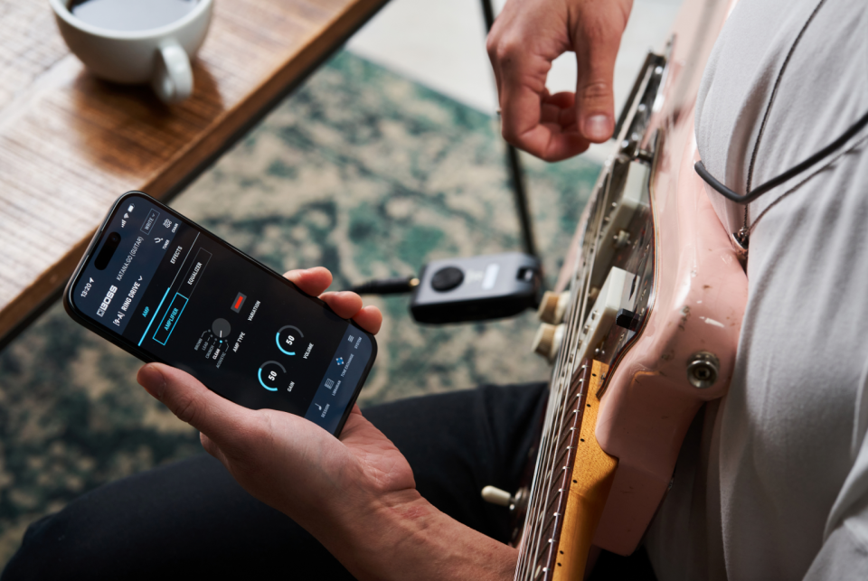 A guitar player using the mobile app. 