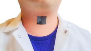 photo shows a shiny black patch made up of small squares stuck to a man
